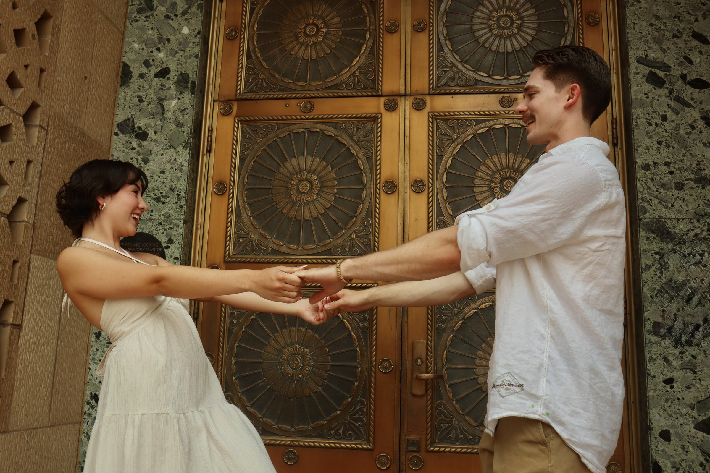 Holding hands in front of the doors